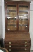 A mahogany bureau bookcase with string inlay.