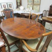 An oval mahogany dining table and 4 chairs.