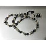 A grey/white/black pearl necklace by Honora.