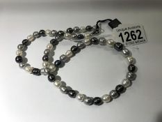 A grey/white/black pearl necklace by Honora.