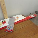 A Ladybird child's height measure, a foot measure and 2 other items.