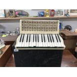 A Hohner Carmen II accordian in box (needs attention)