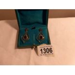 A pair of drop earring stamped 585 (14ct) and 925 (silver) set with garnet and diamonds in green