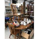 An oval extending table with 6 carved dining chairs