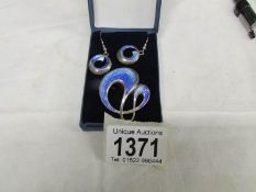 A pair of enamel ear pendants with matching brooch in light and medium blue enamel in the art