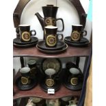 2 shelves of Denby coffee ware consisting of 6 cups and saucers, 4 plates, coffee pot,