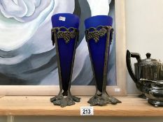 A pair of blue art glass vases in metal frames