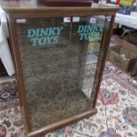 A 2 door collector's cabinet with Dinky Toys transfer on door.