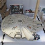 A Star Wars Millenium falcon and a quantity of old star wars figures and accessories.