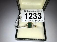 A 9ct gold emerald and diamond ring, size N.