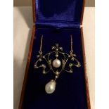 A necklace set with diamonds, seed pearls and pearls in a brown box.
