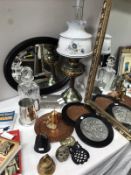 A cut glass decanter, copper plaques, bowbell and oval mirror etc.
