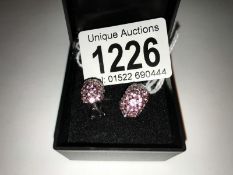 A pair of 18ct, 8.4 white gold pink sapphire earrings.