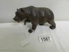 A carved wood Black Forest bear with open mouth.