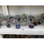 A good collection of 15 glass/crystal paperweights includig mushrooms & handbags etc.