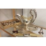 A silver plate saucer boat, fish servers, candle snuffer and 8 napkin rings.