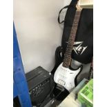 A peavey electric guitar and amplifier beginner / starter kit