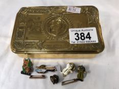 A WWI cigarette box & quantity of pin badges
