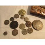 A collection of early coins and medallions in an embossed metal box.