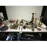 A shelf of mainly brassware including bronze poker stand