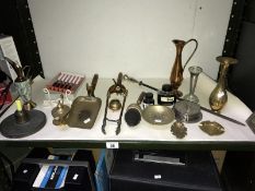A shelf of mainly brassware including bronze poker stand