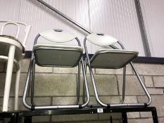 A pair of metal folding chairs