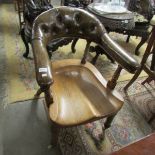 A green leather and oak library chair