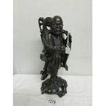 A carved wood Chinese figure.