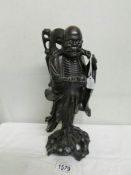 A carved wood Chinese figure.