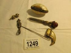 A shell pill box a/f, a hand shaped book mark, a claw hat pin and 2 imp figures,