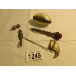 A shell pill box a/f, a hand shaped book mark, a claw hat pin and 2 imp figures,