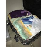A suitcase containing fabrics