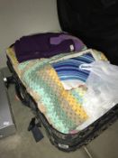 A suitcase containing fabrics