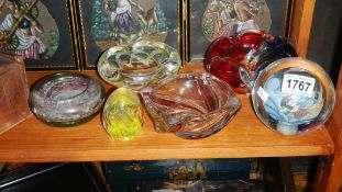 4 coloured glass dishes and 2 glass paperweights.