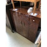 A small side cabinet with double hinged doors