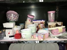 A shelf of kitchenalia including ceramic mixing bowls