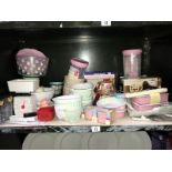 A shelf of kitchenalia including ceramic mixing bowls