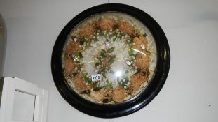 A Victorian wreath in domed glass frame.