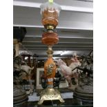 A good Victorian oil lamp on ornate base with amber glass font and original shade (possibly Galle').