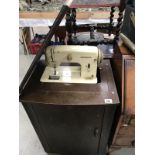 A Bernina sewing machine in a side cabinet