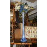A tall blue glass vase.