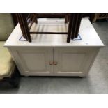 A white painted 2 door low cabinet