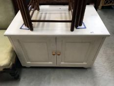 A white painted 2 door low cabinet
