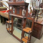 A mahogany over mantel mirror.