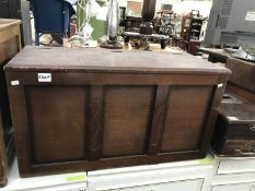 A small carved wood blanket box