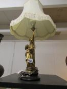 A bronze figural table lamp with shade,.