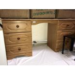 A pine effect kneehole dressing table