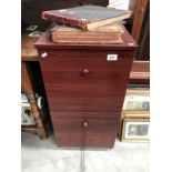 A dark brown 2 drawer filing cabinet