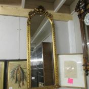 A superb quality gilt framed bevel edged arched top mirror.