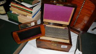 A walnut cased 'Swan's Stereoscopic Treasury' with viewer and cards.